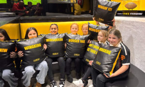 Team holding cushions